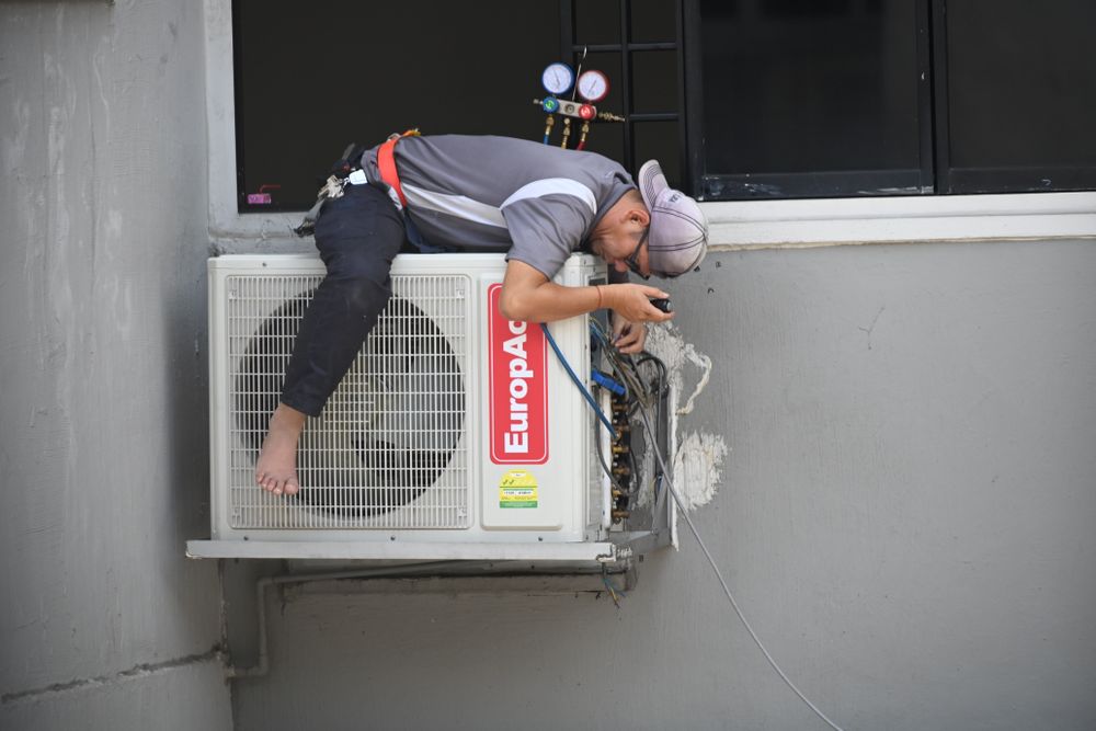 Technician servicing a commercial building air conditioner in Aliso Viejo, CA