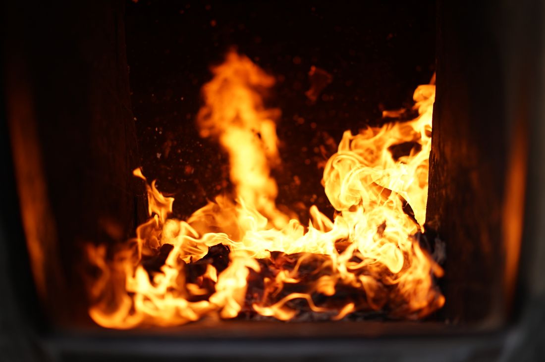 Technician cleaning furnace burners during a tune-up in Aliso Viejo, CA